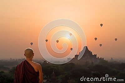 Monk looking at hot air balloons at sunrise at Bagan temple, Burma, Myanmar Editorial Stock Photo