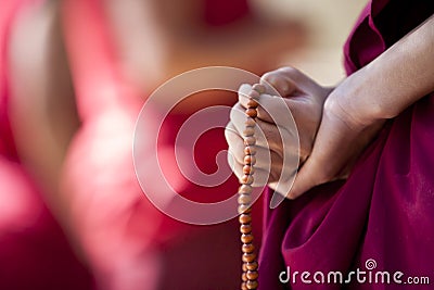 Monk with prayer beads Stock Photo