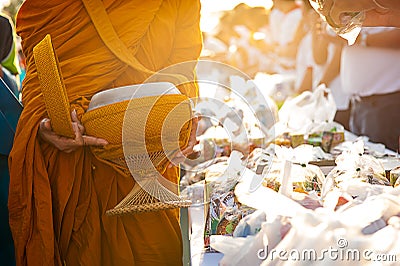 Monk receiving food and items offering from people Stock Photo