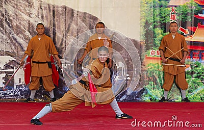 Monk of Shaolin temple performs wushu at Po Lin monastery in Hong Kong, China. Editorial Stock Photo