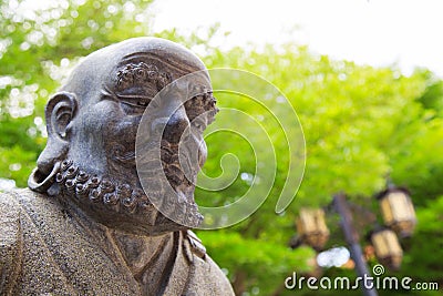 Monk statue in a garden temple Stock Photo