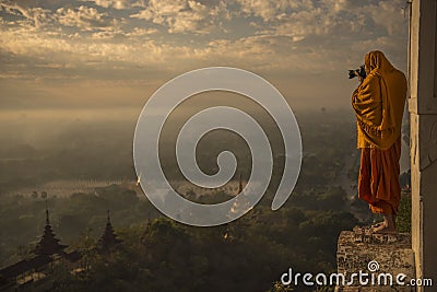 Monk taking photos in the sunrise valley of bagan Editorial Stock Photo