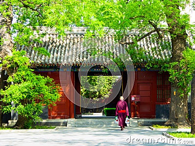 A monk walking inside the lama temple Editorial Stock Photo