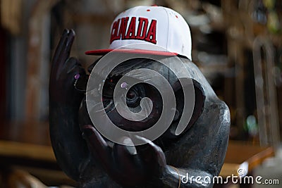 Monkey statue wearing a Canada baseball hat and sunglasses Editorial Stock Photo