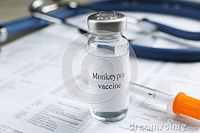 Monkeypox vaccine in vial and syringe on medical forms, space for text Stock Photo