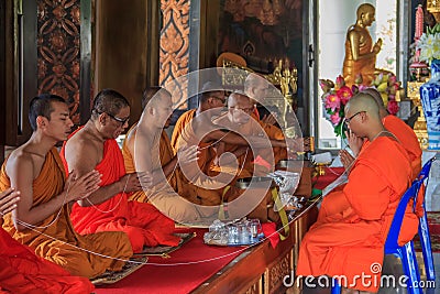 Monks praying in Wat Kaew Korawaram Temple Editorial Stock Photo