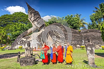 Monks with the Reclining Buddha at Xieng Khuan Buddha Park Vientiane Laos Editorial Stock Photo