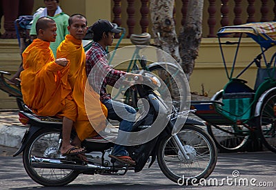Monks on a Scooter in Phnom Penh Editorial Stock Photo