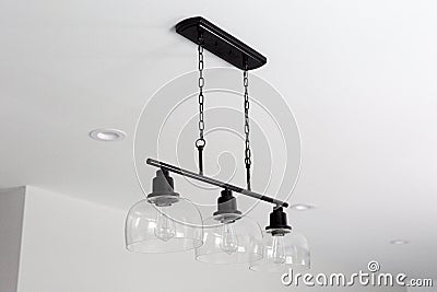Monochromatic Farmhouse Modern Light Fixture with Glass Shades and Recessed Lighting Stock Photo