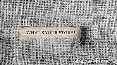 Monochrome image of a rough linen fabric with a torn window in the middle with a Whats your story? sign in it Stock Photo