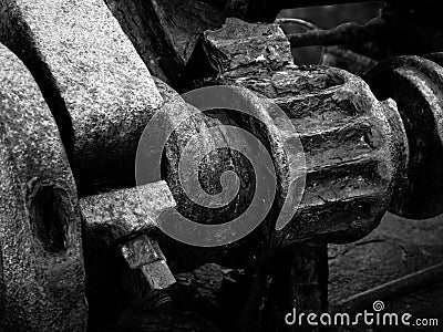 Monochrome image of rusted cogs and gears on an old abandoned broken industrial machinery Stock Photo