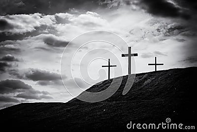 Monochrome image of three crosses sitting on a hill Stock Photo