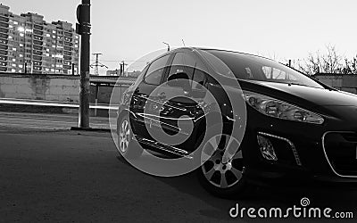 Car in the back of a hatchback in the evening on the background of the evening city. car in the scenery of the city. long exposure Stock Photo