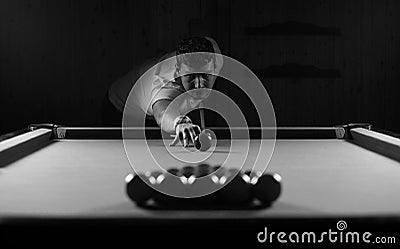 Monochrome photo young man playing billiards Stock Photo