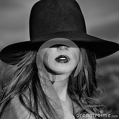 Monochrome portrait of elegant beautiful woman wearing a hat Stock Photo