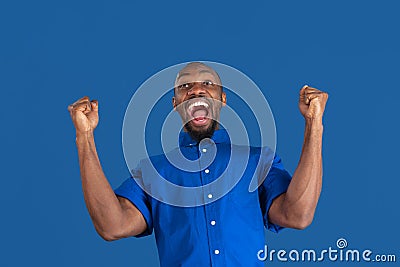 Monochrome portrait of young african-american man on blue studio background Stock Photo