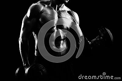 Monochrome shot of an athletic ripped young sportsman with dumbb Stock Photo