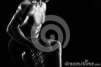 Monochrome shot of an athletic ripped young sportsman with dumbb Stock Photo