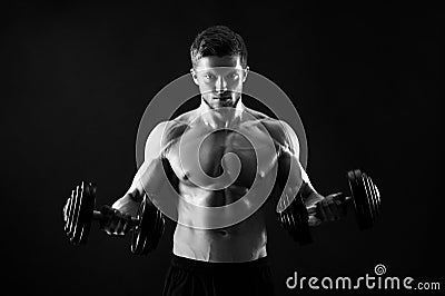 Monochrome shot of an athletic ripped young sportsman with dumbb Stock Photo