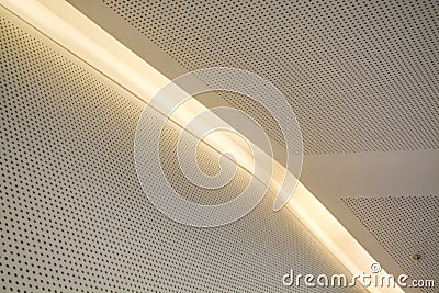 Monophonic background or background in the form of a white covering with illumination and bulbs. Geometry of lines and minimalism. Stock Photo