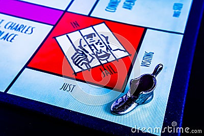 Monopoly Board Game - Boot Token Visiting Jail Editorial Stock Photo