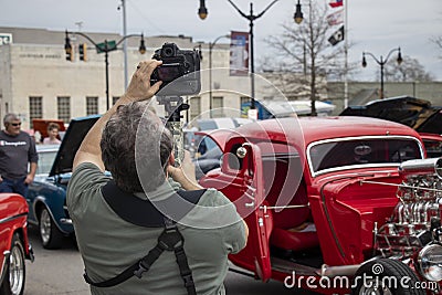 A photographer captures the street scene at a car show in Monroe Georgia. Editorial Stock Photo