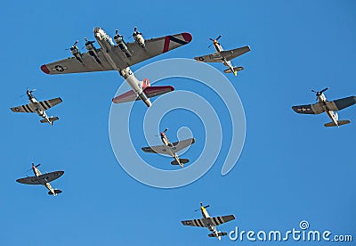 World War II aircraft flying in formation against a deep blue sky Editorial Stock Photo