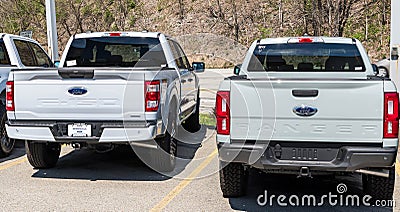 Monroeville, Pennsylvania, USA April 16, 2023 Two new, white Ford pick up trucks, a Ranger and an F150 for sale at a dealership Editorial Stock Photo