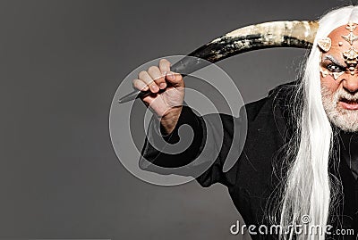 Monster with sharp thorns and warts on face. Wizard demon man with dragon skin and horns. Devil horror concept. Demon Stock Photo