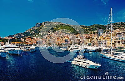 Monte Carlo, Monaco - December 08, 2009: sea harbor with yachts and city on mountain landscape. Houses on sea shore with Editorial Stock Photo