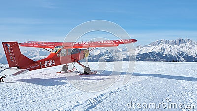 Monte Pora, Bergamo, Italy. A single engined, general aviation red light aircraft parked on a snow covered plateau Editorial Stock Photo