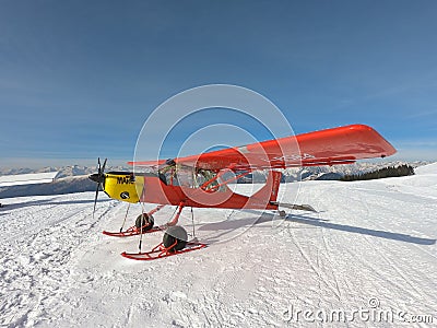 Monte Pora, Bergamo, Italy. A single engined, general aviation red light aircraft parked on a snow covered plateau Editorial Stock Photo