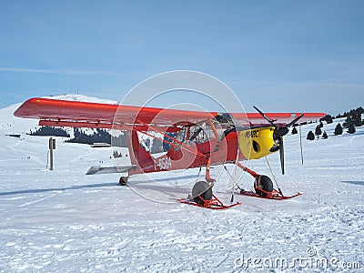 Monte Pora, Bergamo, Italy. A single engined, general aviation red light aircraft parked on a snow covered plateau Editorial Stock Photo