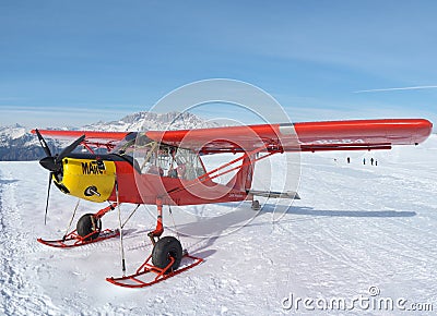 Monte Pora, Bergamo, Italy. A single engined, general aviation red light aircraft parked on a snow covered plateau Editorial Stock Photo