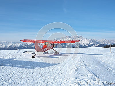 Monte Pora, Bergamo, Italy. A single engined, general aviation red light aircraft on a snow covered plateau is taking off Editorial Stock Photo