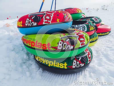 Monte Pora, Italy. Colorful rubber or plastic ski ring to slide on the snow. Fun in the winter season Editorial Stock Photo