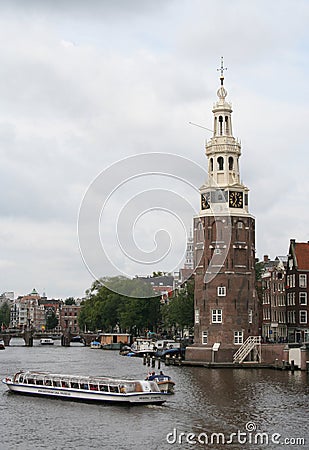 The Montelbaanstoren is a tower on bank of the canal Oudeschans in Amsterdam Editorial Stock Photo