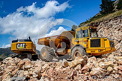 Montenegro, Cetinje - June, 29, 2017: Dumper with excavator on a stone mountain road Editorial Stock Photo