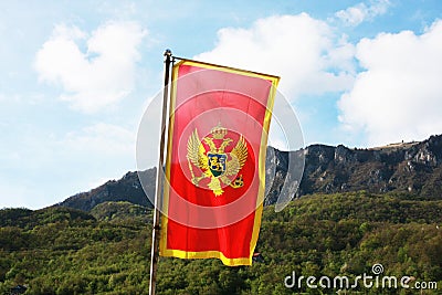 Montenegro flag in a front of mountains Stock Photo