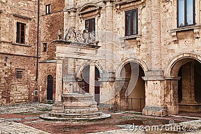 Montepulciano, Siena, Tuscany, Italy: the ancient Griffin and Lion Well 1520 in a corner of the main square Stock Photo