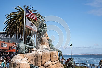 Cannery Row Monument with flags of America and California at coastline Editorial Stock Photo