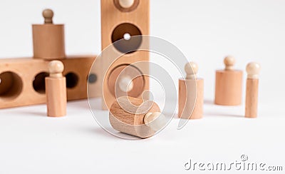 Montessori knobbed wooden cylinders with blocks. Kids puzzle for development of eye hand coordination and concentration Stock Photo