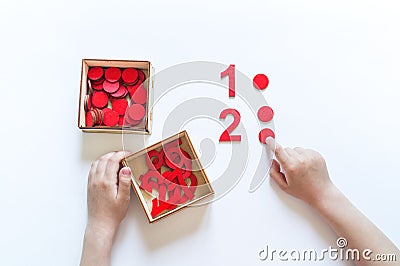 Montessori material. Children`s hands. The study of mathematics Stock Photo