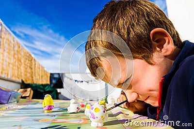 In Montessori schools, children practice art by painting plaster sculptures Stock Photo
