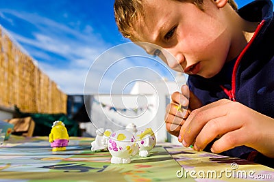 In Montessori schools, children practice art by painting plaster sculptures Stock Photo