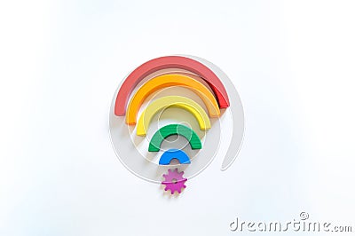 Montessori wood rainbow material. A child plays with a toy with his hands. Wi-Fi Stock Photo