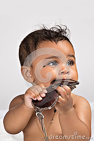 7 month old chewing on sunglasses Stock Photo