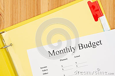 Monthly Budget type message with file tabs in a yellow binder Stock Photo