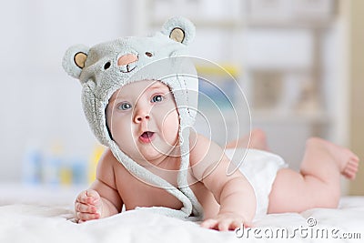 5 months baby girl weared in funny hat lying down on a blanket Stock Photo