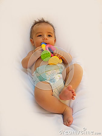 3 months old baby boy playing with teething toy Stock Photo